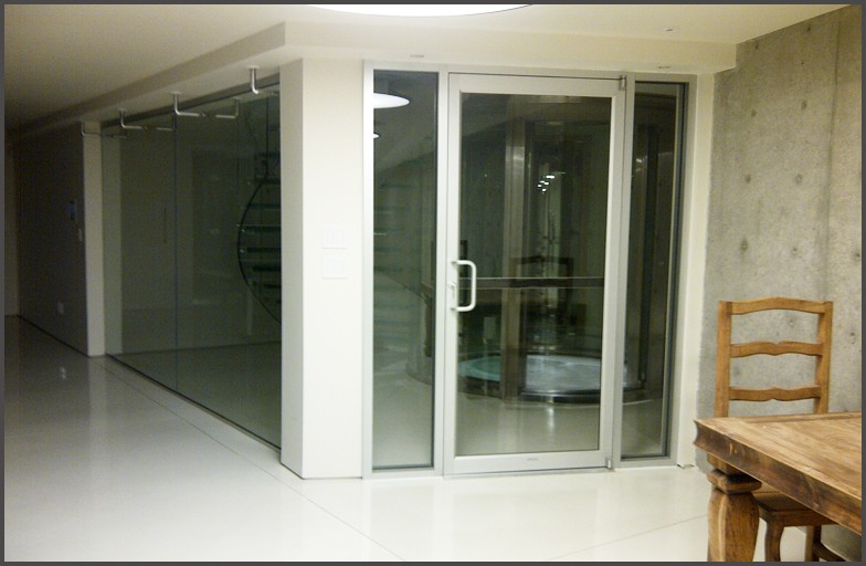 Glass doors with aluminum frames for this Vancouver west home elevator room.