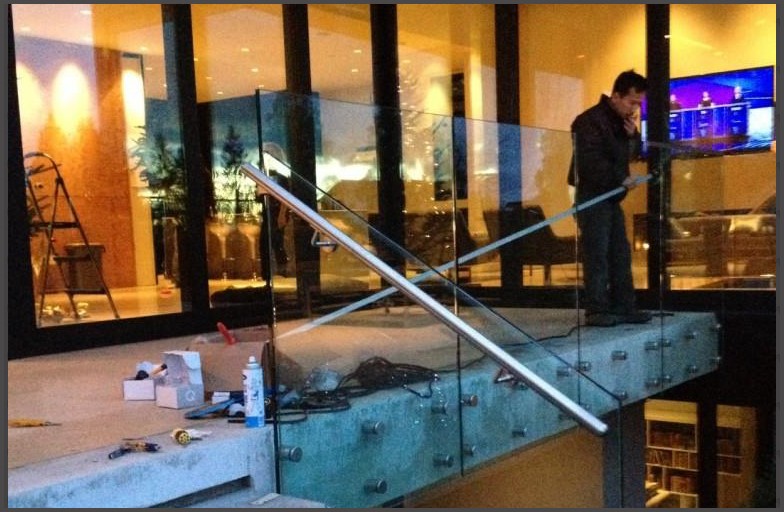 Glass railing was designed with standoff bolts, the laminated tempered clear glass provides extra safety features such as if the glass was ever broken due to an accidental impact., when the glass breaks the laminated clear film keeps the glass panels together and most of the time standing up, this will prevent anyone from falling. The stand off bolts that holds the glass panels secured are strong enough to keep the glass panels standing without having any frames. This provides an architechural design look while providing optimal view of the ocean from the home windows. Glass railing handrails were also supplied and installed for the walk up stairs, these handrails were cut to fit, while glass fitting to hold the handrails on the glass were installed.