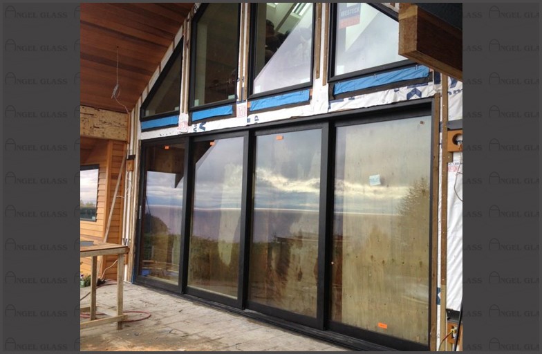 Large patio door, sliding glass doors, commercial aluminum window frames, double pane clear glass, large aluminum skylight frame and glass installed for this West Vancouver custom home.