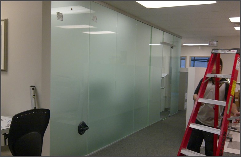 TROTTER - Frosted Glass Wall and office glass door. Glass door and glass walls were designed with frosted glass, and door hardware that provide a separation between an office hallway with an office room.