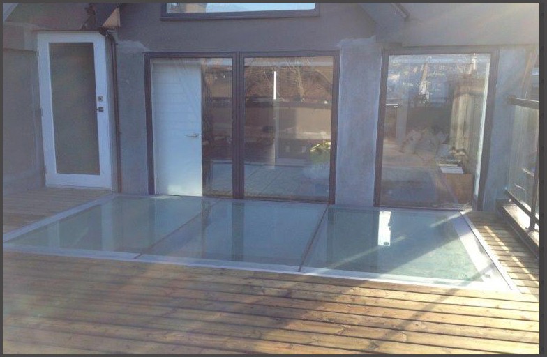 Point Grey - Glass roof, also use as a skylight to allow light below the kitchen, but it also had been engineered so people can walk on it like a structural glass floor with non slip materials adhere to the glass. A successful job completed by Angel Glass designers, our suppliers to cut and build the glass as per our specification, and our installers to have the glass crane and installed.