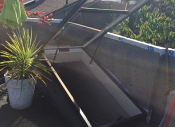 Residential Large Drop-in Skylight replacement for this Vancouver home.  Large roof hatch skylight was installed that could open.