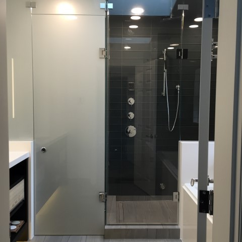 Shower door company located in Vancouver B.C. Frosted shower door and frameless shower door for this home bathroom, installed by Angel glass installers.