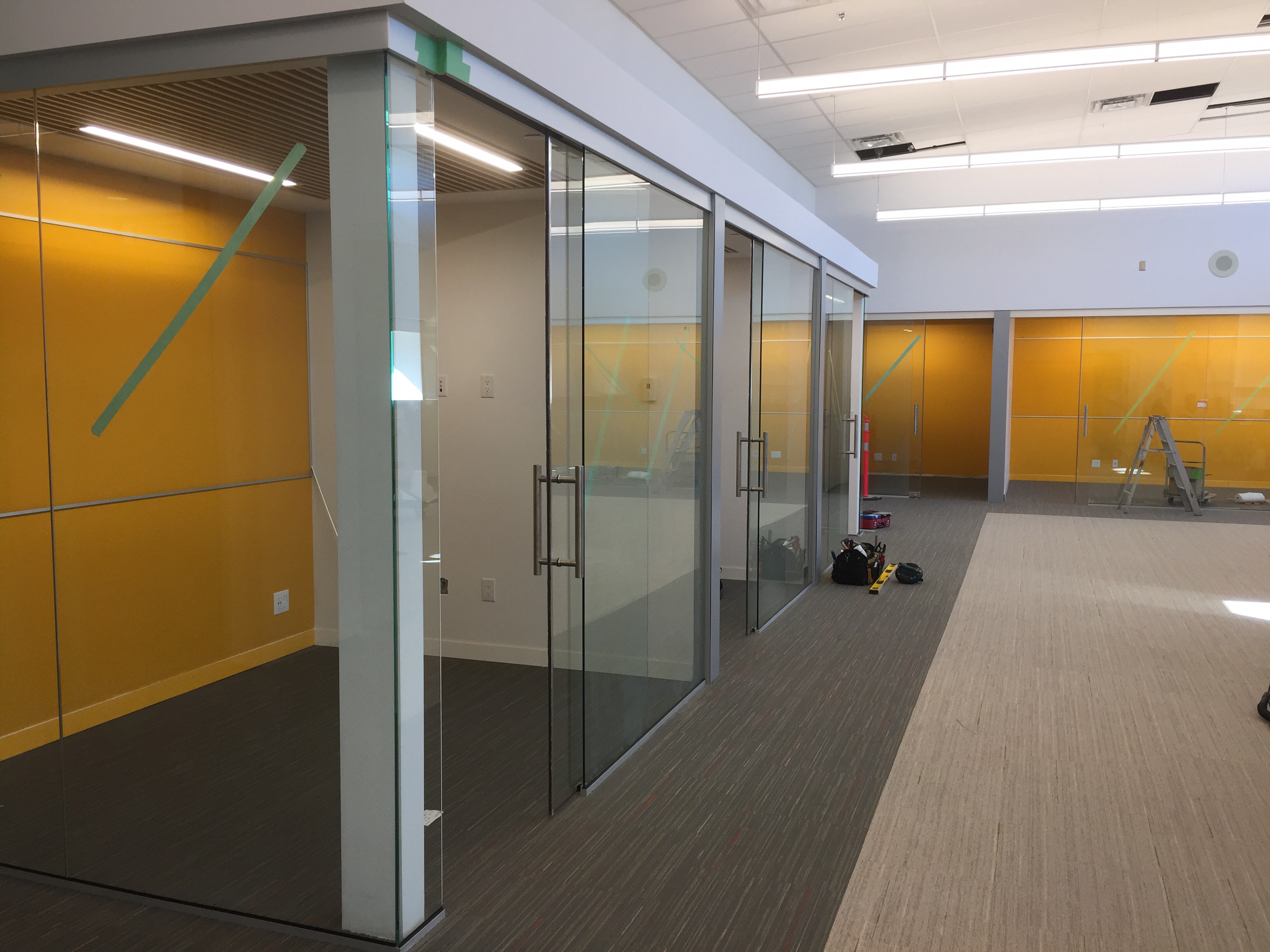 Interior office glass walls, sliding glass doors, curtain wall, colored writing glass walls, all shop drawing designed build and installed by Angel Glass