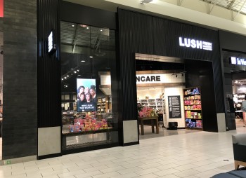 Glass wall for Lush at shopping mall front. 16 feet tall large oversized glass wall and metal wrappings at mall front walls