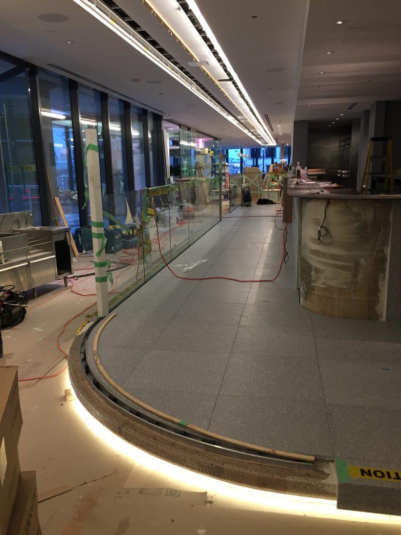 restaurant podium curved railing frames installation in preparation for curved glass railing