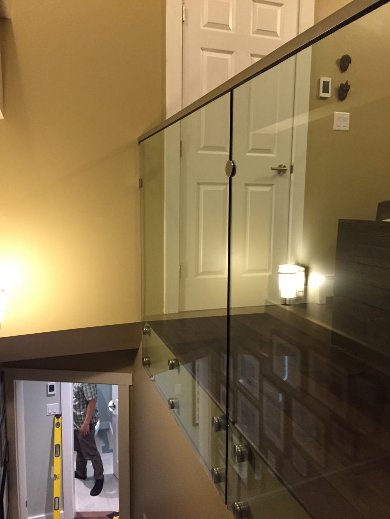 custom glass railing with side bolts and handrails